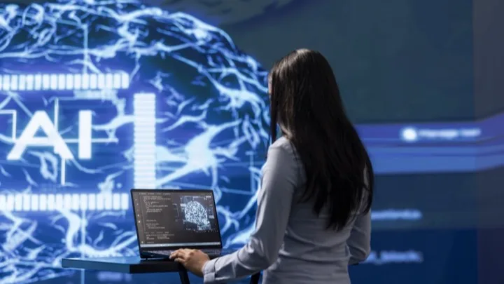 Woman working with artificial intelligence on laptop