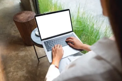 Person using laptop in private setting
